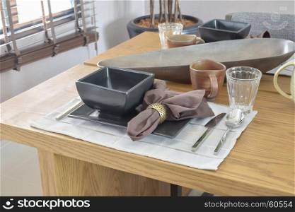 dining wooden table in modern home with elegant table setting