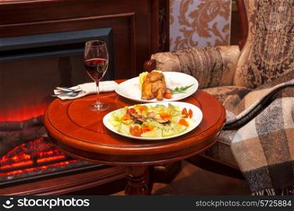Dinner at table and on fireplace background