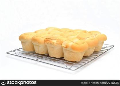 Dinner Roll. Brown and serve dinner rolls on a wire bakers cooling rack
