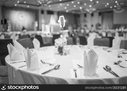 Dinner table in the luxury banquet room of the hotel, black and white