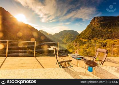 Dinner table with grill outdoor in norwegian mountains with view over Geiranger fjord. Traveling, camping on nature.. Dinner table with grill on norwegian nature