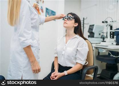 Diopter selection, diagnostics of vision, professional choice of glasses. Eyesight test in optician cabinet. Patient and ophthalmologist, eye care consultation. Diopter selection, glasses choice, eyesight test
