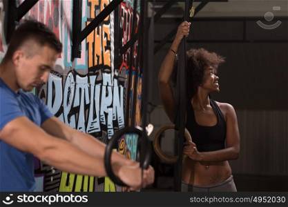 dip ring young man and african american woman relaxed after workout at gym dipping exercise