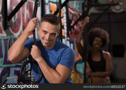 dip ring young man and african american woman relaxed after workout at gym dipping exercise