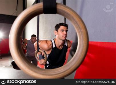 Dip rings workout man view from a ring hole at gym
