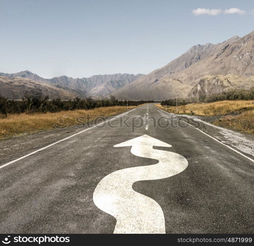 Direction sign on road. Natural landscape of asphalt road and drawn twisting arrow