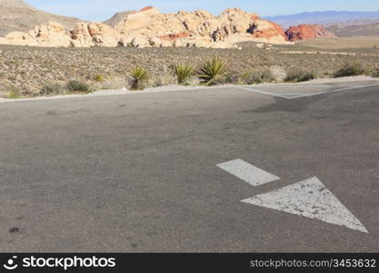 Directional arrow on the empty parking lot in Mojave Desert, Nevada.