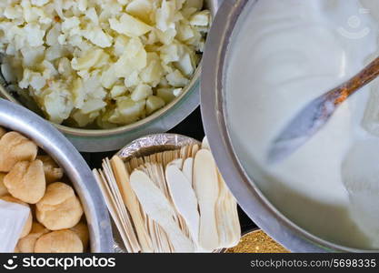 Directly above shot of yogurt and potatoes in containers