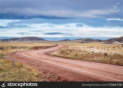 Dirt ranch road at foothills in northern Colorado, early spring scenery