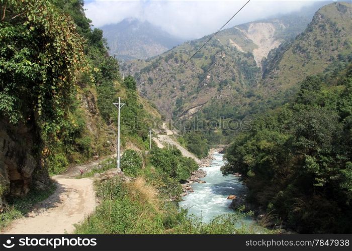 Dirt road and mountain river in Nepal