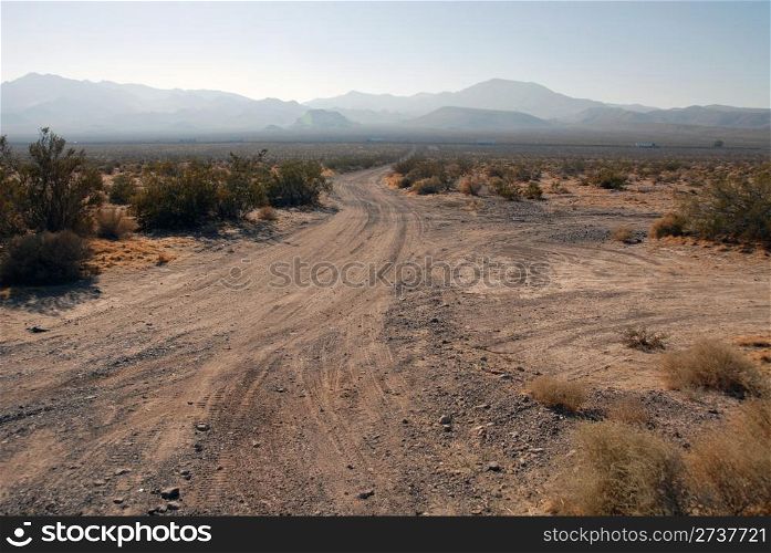 Dirt road, Interstate and mountains in the distance, Yermo, California