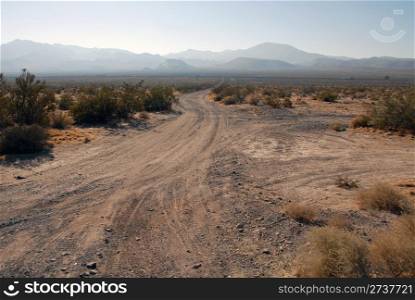 Dirt road, Interstate and mountains in the distance, Yermo, California