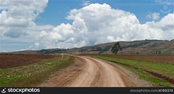 Dirt road passing through an agricultural field, Sacred Valley, Cusco Region, Peru