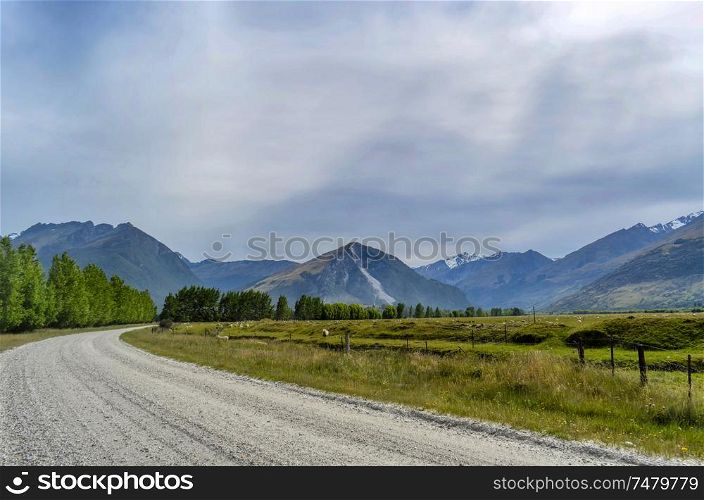Dirt road through typical mountainous countryside near Queenstown, New Zealand