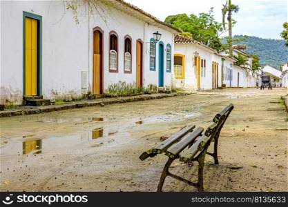 Dirt street wet by rain and colonial-style houses in the old and historic city of Paraty. Dirt street wet by rain and colonial-style houses in Paraty
