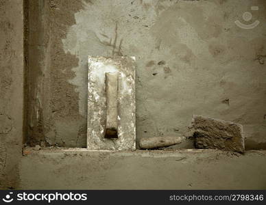 dirty grunge cement trowel hand tools on fresh mortar wall