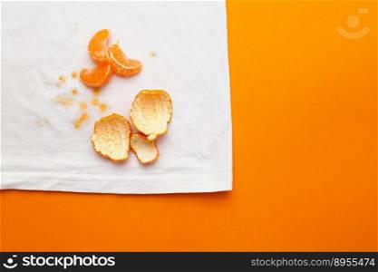 dirty stains on white clothes from fruits mandarin on orange background.. dirty stains on white clothes from fruits mandarin on orange background