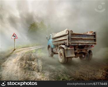 Dirty truck on a country road and cloudy sky