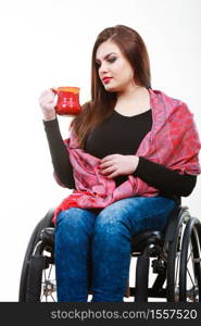 Disability drink relax leisure concept. Cheerful crippled lady on wheelchair. Smiling disabled girl holding red cup drinking beverage.. Cheerful crippled lady on wheelchair.