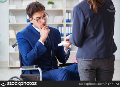 Disabled businessman having discussion with female colleague