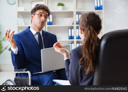 Disabled businessman having discussion with female colleague