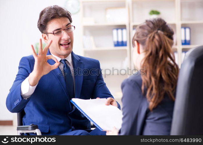 Disabled businessman having discussion with female colleague