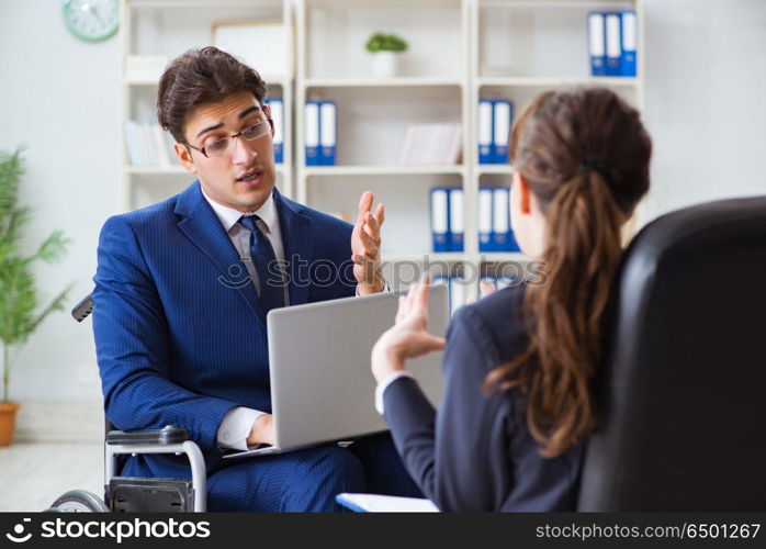 Disabled businessman having discussion with female colleague