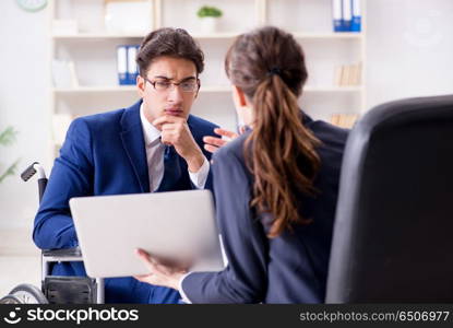 Disabled businessman having discussion with female colleague