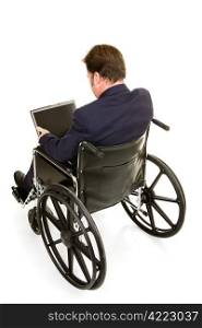 Disabled businessman in wheelchair working on computer. Full body isolated on white.