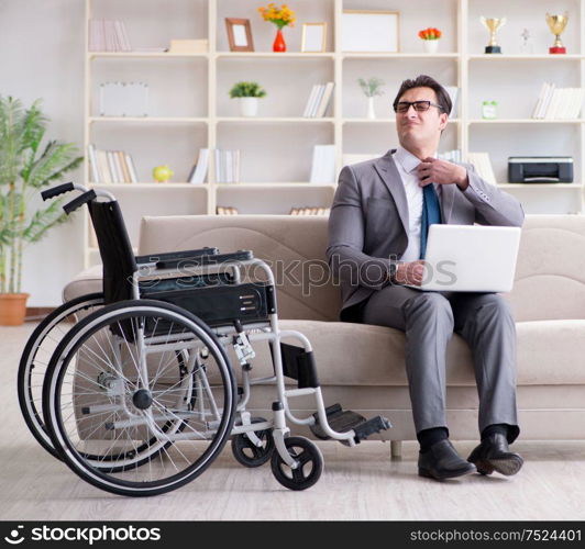 Disabled businessman on wheelchair working home. Dsabled businessman on wheelchair working home
