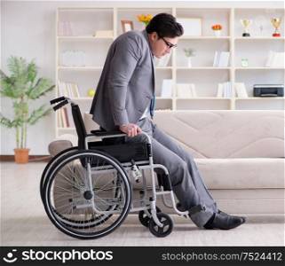 Disabled businessman on wheelchair working home. Dsabled businessman on wheelchair working home