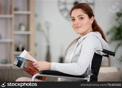 disabled girl delighted to read her magazine