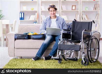 Disabled man booking travel online using laptop computer