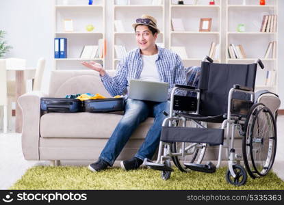 Disabled man booking travel online using laptop computer