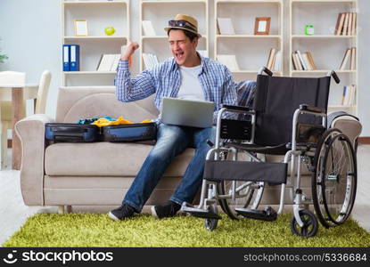 Disabled man booking travel online using laptop computer