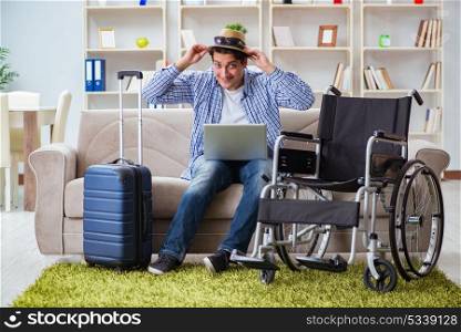 Disabled man booking travel online using laptop computer