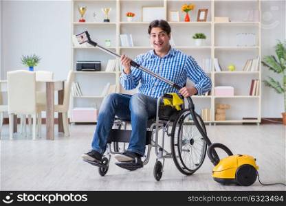 Disabled man cleaning home with vacuum cleaner