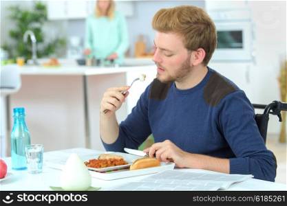 Disabled man eating a meal