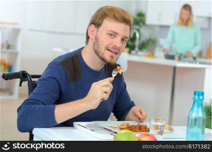 Disabled man having his lunch