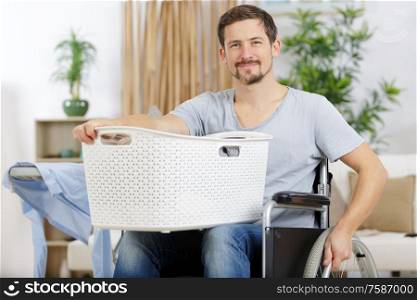 disabled man in wheelchair doing laundry