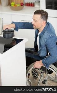 disabled man in wheelchair in the kitchen
