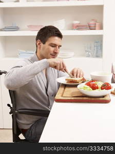 Disabled Man Making Sandwich In Kitchen