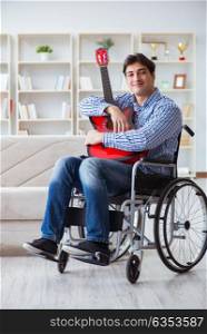 Disabled man playing guitar at home