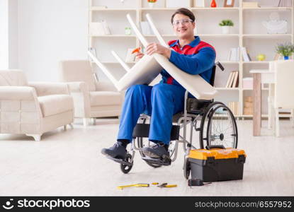 Disabled man repairing chair in workshop