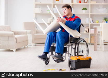 Disabled man repairing chair in workshop