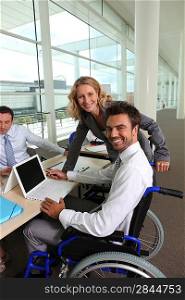 Disabled man with colleagues