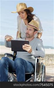 disabled man with digital tablet