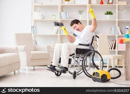 Disabled man with vacuum cleaner at home