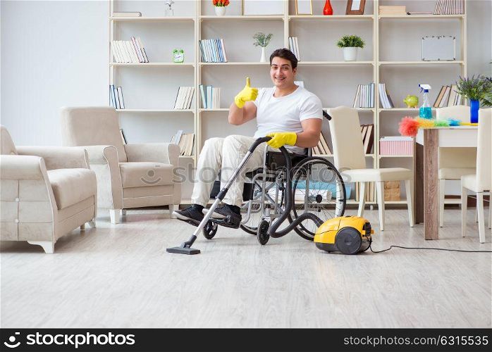 Disabled man with vacuum cleaner at home