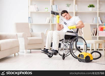 Disabled man with vacuum cleaner at home